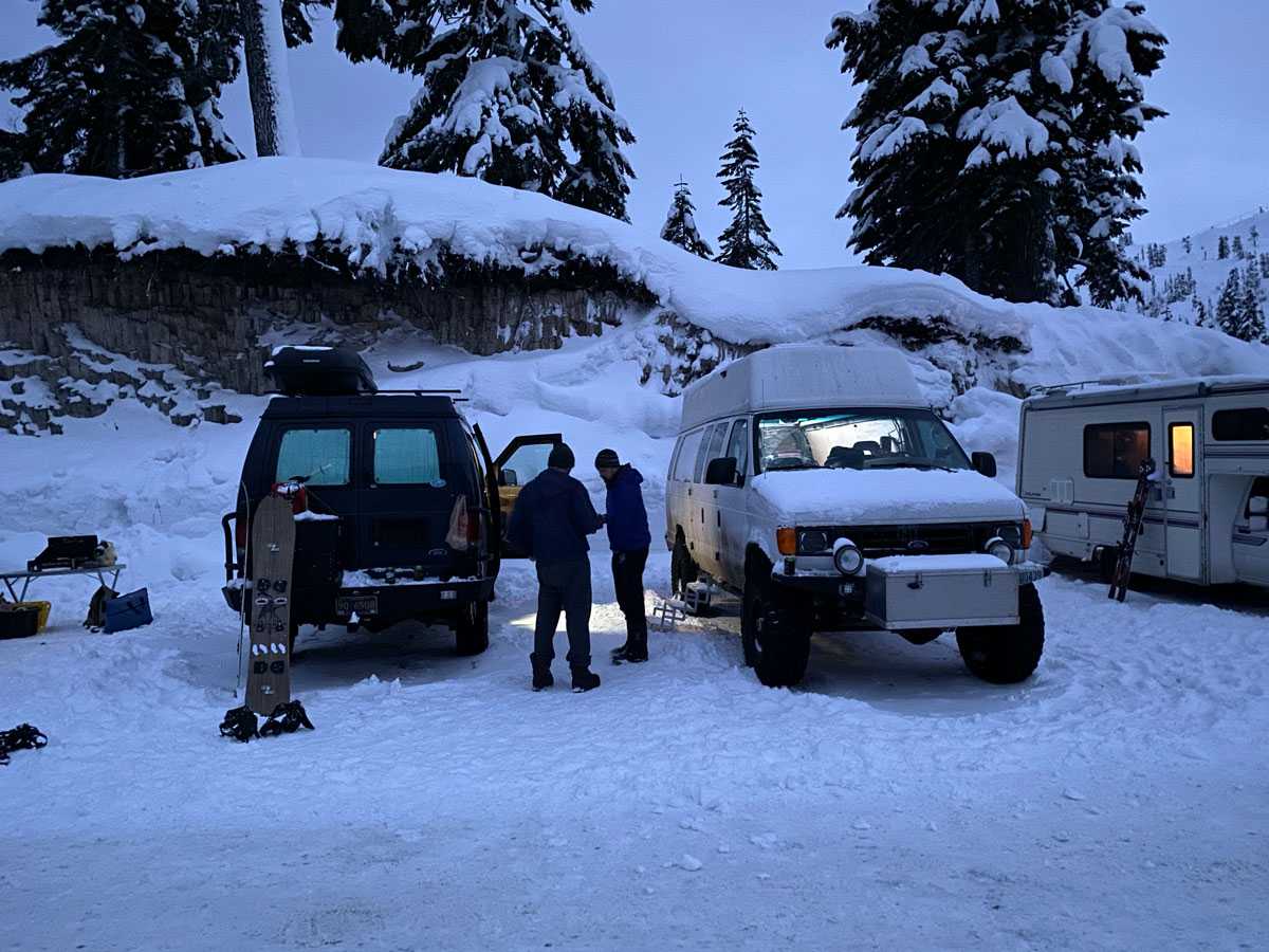 Our two vans in the snowy Heather Meadows parking lot