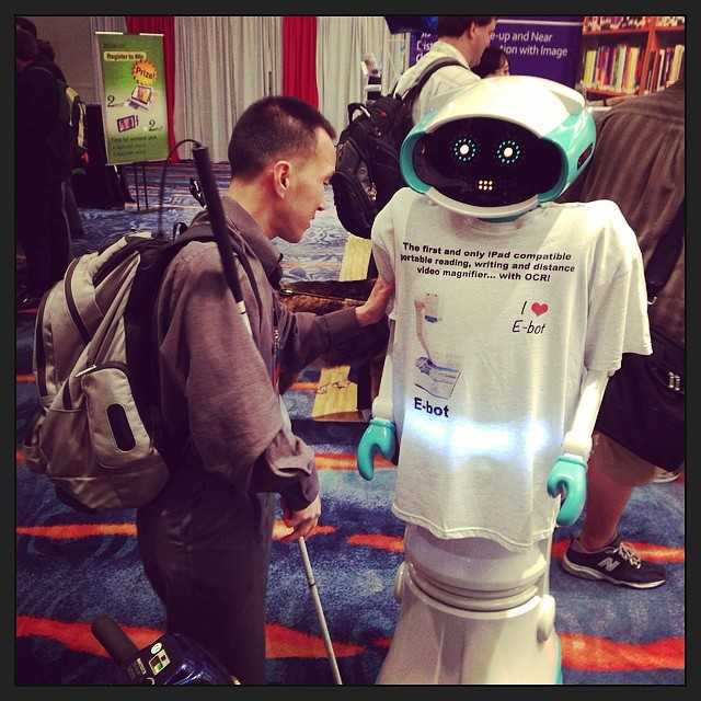 A blind man talking to a robot